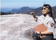  ?? TRACIE CONE/ ASSOCIATED PRESS ?? Sequoia National Park’s Annie Esperanza explains how ozone diminishes the view from Beetle Rock in Sequoia National Park, Calif.