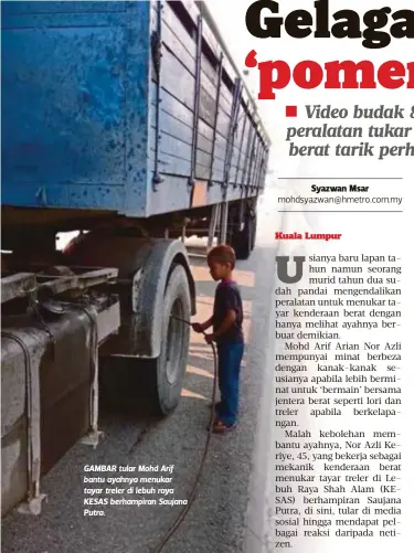  ??  ?? GAMBAR tular Mohd Arif bantu ayahnya menukar tayar treler di lebuh raya KESAS berhampira­n Saujana Putra.