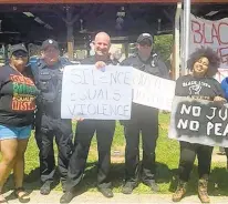  ?? BRIDGETT CRAIGHEAD VIA THE NEW YORK TIMES ?? A photo shows Bridgett Craighead with Sgt. Thomas Robertson, center, and Officer Jacob Fracker, second from right, at a Black Lives Matter rally in Rocky Mount, in 2020.