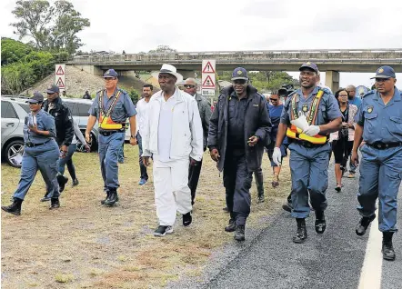  ?? Picture: MALIBONGWE DAYIMANI ?? WARPATH: Police minister Bheki Cele and commission­er General Khehla Sitole lead a police contingent at a roadblock on Thursday.