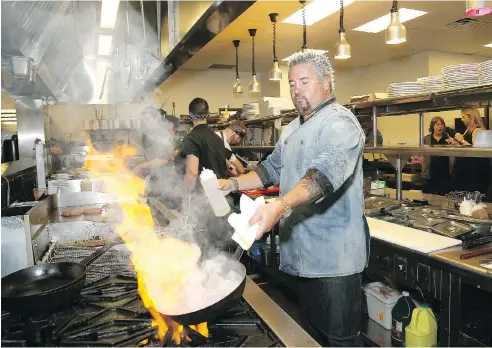  ?? PAUL ZIMMERMAN / GETTY IMAGES FOR MOUNT AIRY CASINO RESORT ?? Celebrity chef Guy Fieri prepares a meal in his restaurant at Mount Airy Casino Resort in 2016 in Mount Pocono, Pa.