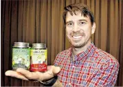  ?? DARRELL SAPP / ?? Samuel Hopkins holds his two new products, eco-friendly lubricants, after he competed in Walmart’s Open Call event and scored a deal to sell his products.