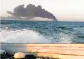  ?? ASRIRAN.COM ?? An image from video taken Wednesday shows smoke rising from the largest warship in Iran’s navy after it caught fire. The ship later sank in the Gulf of Oman.