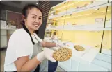  ?? Associated Press ?? Pastry chef Elaine Lau holds a Dim Sum Cookie at the Sunday Bakeshop in Oakland, Calif.,on Aug. 19.