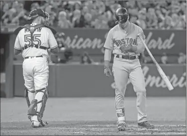  ?? Associated Press ?? Down on strikes: In this April 24, 2018, file photo, Boston Red Sox's Andrew Benintendi strikes out during the eighth inning for his fourth strikeout of the night, as Toronto Blue Jays catcher Russell Martin walks away during a baseball game in...