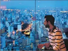  ??  ?? “IT’S LIKE science fiction,” says Wahib Hayek, 24, of the view from a Sao Paulo high-rise. “And people ask why I came to Brazil.”