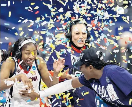  ?? ELSA/GETTY ?? Aari McDonald and coach Adia Barnes of the Arizona Wildcats are showered with confetti after a 66-53 victory over the Indiana during the Elite Eight round of the NCAA Women’s Basketball Tournament at the Alamodome on March 29, 2021 in San Antonio, Texas.