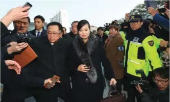  ??  ?? Hyon Song-Wol (center), leader of North Koreaís popular Moranbong band, arrives at the Gangneung Arts Center where one of the planned musical concerts is due to be held, in the eastern city of Gangneung yesterday. — AFP photos