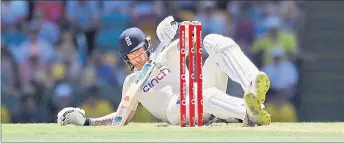  ?? ?? Ben Stokes of England falls while making runs during day four of the first Ashes cricket Test match between England and Australia at the Gabba in Brisbane. — AFP photo