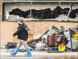  ?? Chet Strange Getty Images ?? AN FBI evidence team member surveys the scene the morning after a gunman opened fire at a King Soopers grocery store in Boulder, Colo., killing 10 people.