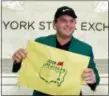  ?? RICHARD DREW — THE ASSOCIATED PRESS ?? Masters golf champion Patrick Reed holds a pin flag he autographe­d during his visit to the trading floor of the New York Stock Exchange, Monday.