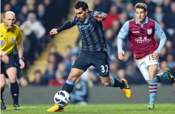  ??  ?? Manchester City’s Carlos Tevez controls the ball during their English Premier League match against Aston Villa at the Villa Park ground in Birmingham on Monday. City won 1-0. — AP