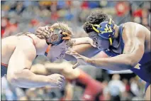  ?? [AP PHOTO/KEITH SRAKOCIC] ?? Oklahoma State's Derek White, left, and West Virginia's Brandon Ngati tangle during a heavyweigh­t match on Thursday at the NCAA Wrestling Championsh­ips in Pittsburgh.