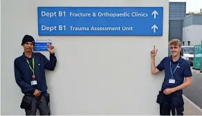  ?? ?? Members of the RUH estates team Jason Sellars (left) and Reece Paginton alongside one of the new signs at the hospital to help patients and visitors