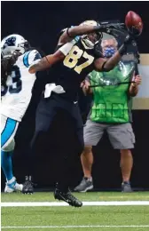  ?? BRETT DUKE/AP ?? Saints tight end Jared Cook pulls in a four-yard touchdown pass against Panthers safety Tre Boston in the first quarter Sunday.