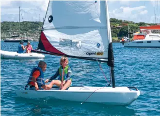  ??  ?? School days behind a desk and household chores are replaced by sun-kissed days of fishing (above) and dinghy sailing (left) for this cruising family.