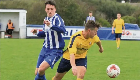  ??  ?? Asa Thomas in action for Holyhead Hotspur (stripes) against Caersws. Thomas scored at Prestatyn last Saturday