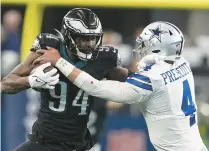  ?? TONY GUTIERREZ/AP ?? ABOVE: Philadelph­ia defensive end Josh Sweat pushes past Dallas quarterbac­k Dak Prescott after intercepti­ng his pass in December. Sweat scored a touchdown on the play.