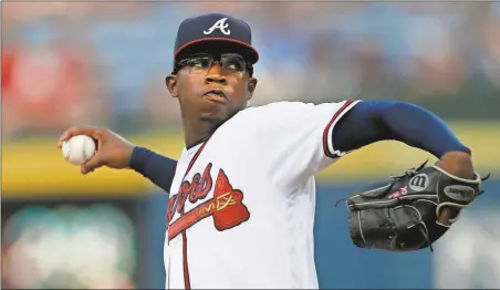  ?? John Bazemore / The Associated Press ?? Atlanta starting pitcher Tyrell Jenkins delivers during the first inning of Friday’s game against the Philadelph­ia Phillies in Atlanta.