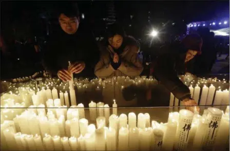  ?? AHN YOUNG-JOON — THE ASSOCIATED PRESS ?? Buddhists place candles during New Year celebratio­ns Jan. 1, at Jogyesa Buddhist temple in Seoul, South Korea.