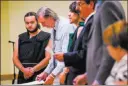  ?? Chase Stevens ?? Las Vegas Review-journal Dakota Saldivar, left, and Michael Wilson, center, appear for arraignmen­t Thursday in Pahrump Justice Court.The 17-year-olds face charges in the stabbing death of their mother.