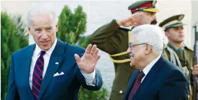  ?? ( Mohamad Torokman/ Reuters) ?? THEN- VICE PRESIDENT Joe Biden gestures as he walks with Palestinia­n Authority President Mahmoud Abbas after their meeting in Ramallah in 2010.