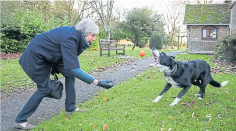  ?? Picture: PA. ?? Prime Minister Theresa May throws a ball for a border collie called Blitz as she and her husband Philip leave following a church service near her Maidenhead constituen­cy.