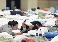  ??  ?? Guests try to pass the time in the ballrooms of the Atlantis Paradise Island Hotel as Hurricane Matthew moves away from the resort island in Nassau, Bahamas, yesterday.