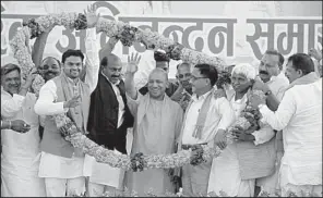  ?? Tribune News Service/Hindustan Times/DEEPAK GUPTA ?? Supporters cheer Yogi Adiyanath (center), the new chief minister of India’s Uttar Pradesh state, on his first visit to his hometown of Gorakhpur after a swearing-in ceremony March 25. His followers believe he will realize their dream of a temple to the Hindu god Ram.