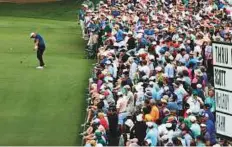  ?? AP ?? Adam Scott of Australia takes a shot on the 15th hole in front of a packed crowd on Friday.