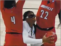  ?? MORRY GASH — THE ASSOCIATED PRESS ?? Stanford’s Francesca Belibi looks to shoot between Louisville’s Elizabeth Balogun and Elizabeth Dixon during the first half of Tuesday’s gane in San Antonio.