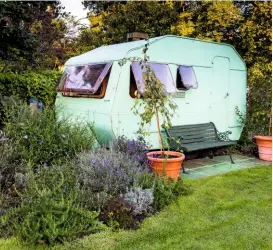  ??  ?? Crab apples in pots outside the caravan are Malus ‘Red Jade’, and perennials include rosemary, Lavandula x intermedia ‘Grosso’ and Caryopteri­s clandonens­is.