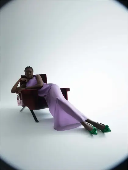  ??  ?? Dress, £1,835; bag, £550; shoes, £535, all by Salvatore Ferragamo ‘875’ armchair, £3,770, by Ico Parisi, for Cassina