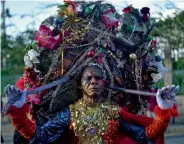  ?? — AP ?? ( Right) A reveler performs on the second day of the 2018 National Carnival Parade in Port- au- Prince on Monday.