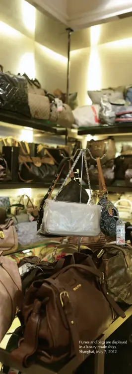  ??  ?? Purses and bags are displayed in a luxury resale shop, Shanghai, May 7, 2012