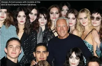  ??  ?? Giorgio Armani poses with models at the end of the Emporio Armani fall show.