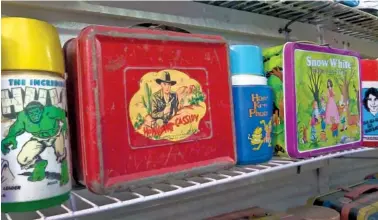  ?? ASSOCIATED PRESS FILE PHOTO ?? A Hopalong Cassidy lunch box, center, is among the many boxes Allen Woodall has on display at the Lunch Box Museum.