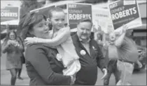  ?? JONATHAN HAYWARD, THE CANADIAN PRESS ?? B.C. Liberal leader Christy Clark carries a child during a campaign stop in Sidney, B.C., Monday. The British Columbia election will be held on Tuesday.