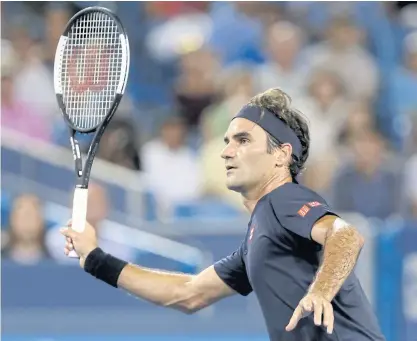  ??  ?? Roger Federer returns a shot to Stan Wawrinka during their quarter-final match.