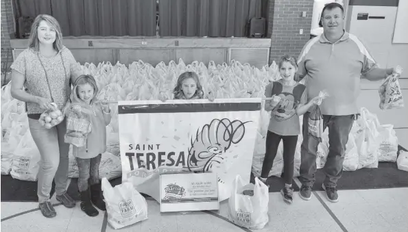  ?? [WHITNEY NEILSON / THE OBSERVER] ?? St. Teresa of Avila Catholic Elementary School in Elmira wrapped up its Fresh from the Farm fundraiser this week which raised money for the school and gave some of the produce to the local food bank. Here, the orders are all bundled and waiting to be...