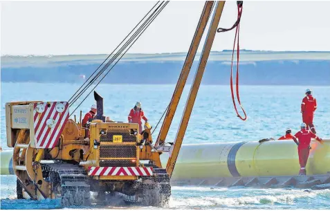  ?? ?? An undersea pipeline is launched before it is attached to a tow boat. A cable across the Atlantic would be the world’s longest and most challengin­g project to date