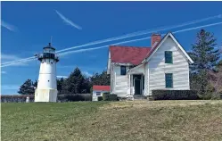  ?? BARBARA SALFITY/GENERAL SERVICES ADMINISTRA­TION VIA THE NEW YORK TIMES ?? The Warwick Neck Lighthouse in Warwick, R.I., one of the 10 lighthouse­s the government plans to unload. The General Services Administra­tion says four are slated for auction, and six have been offered to local, state and federal agencies; nonprofits; and other groups that have the funds to maintain them.