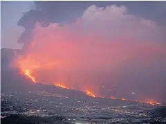  ?? ?? LAVA LIGHT: The Cumbre Vieja volcano, pictured from Tijarafe, spews lava, ash and smoke on the Canary Island of La Palma on Tuesday.