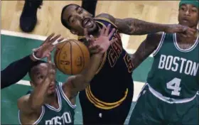  ?? CHARLES KRUPA — THE ASSOCIATED PRESS ?? Cavaliers guard JR Smith (5) battles for a rebound against Celtics guard Avery Bradley, left, during the first quarter Boston on April 5, 2017. At right is Celtics guard Isaiah Thomas.