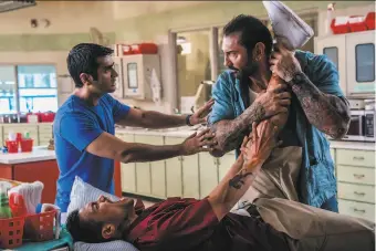  ?? Hopper Stone / SMPSP ?? Kumail Nanjiani (left) plays Uber driver Stu in “Stuber,” with Rene Moran as a gunshot victim in a scene with an overaggres­sive cop played by Dave Bautista.
