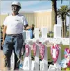  ?? Richard Brian ?? Las Vegas Review-journal Greg Zanis, of Aurora, Ill., stands next to the 58 crosses he placed on the Strip in September memorializ­ing the Oct. 1 dead.