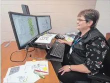  ?? BOB TYMCZYSZYN TORSTAR ?? Transporta­tion co-ordinator Ann Erb looks overbus routes and maps as Niagara Student Transporta­tion Services prepares for the school year.