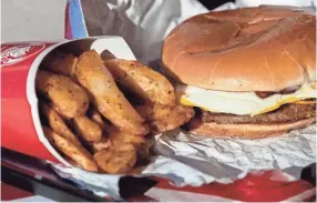  ??  ?? The Breakfast Baconator and breakfast potatoes are available on Wendy’s new breakfast menu.