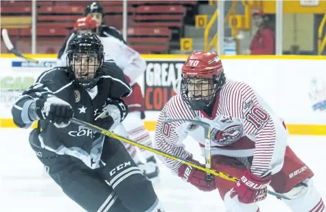  ?? JULIE JOCSAK/ POSTMEDIA NEWS ?? Tanner Main of the St. Catharines Falcons and Dorian Maye of the Caledonia Corvairs keep thier eye on the puck in jr B hockey action at the Jack Gatecliff Arena in St. Catharines on Friday.