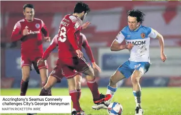  ?? MARTIN RICKETT/PA WIRE ?? Accrington­y’s Seamus Conneely challenges City’s George Honeyman